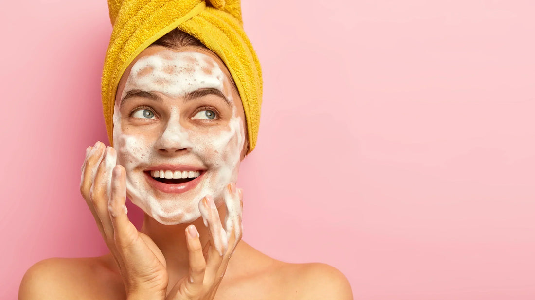 Young lady washing her face with micro bubble foam